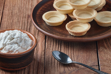 Freshly baked tartlets on a plate.