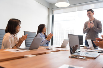 Business people are discussing about their work. Happy boss is talking to employee at workplace. Setup studio shooting.