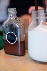 Glass bottles with cold coffee cocktails and cold milk