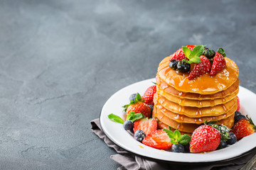 Stack of homemade pancakes for breakfast with berries