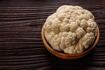 fresh cauliflower on a rustic wooden background