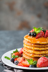 Stack of homemade pancakes for breakfast with berries