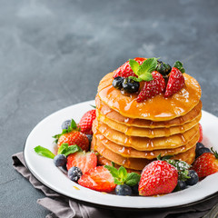 Stack of homemade pancakes for breakfast with berries