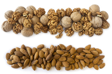 Obraz premium Walnuts and almonds isolated on a white background. Nuts with copy space for text. Kernels walnuts and almonds on a white background. Top view. 