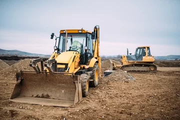 Fotobehang Vrachtwagen Industrial backhoe excavator loader and bulldozer machinery on construction site  © aboutmomentsimages