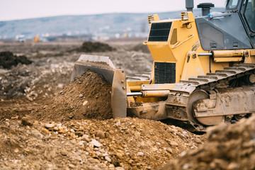 highway construction site close up with industrial machinery, excavator and bulldozer working