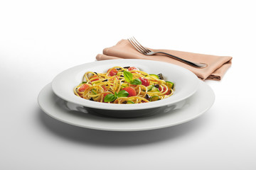 Pasta dish Spaghetti and vegetables with napkin and fork