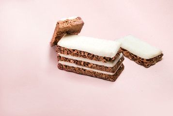 Chocolate cereal oat cracker with vanilla cream top icing