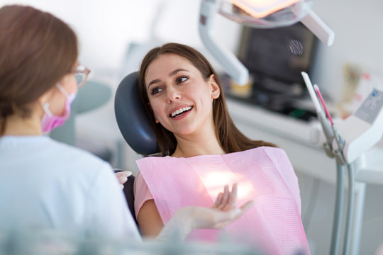 Dentist And Patient In Dentist Office
