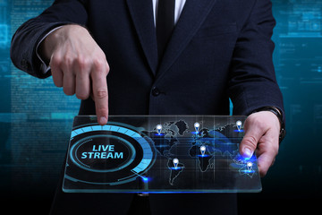 Business, Technology, Internet and network concept. Young businessman working on a virtual screen of the future and sees the inscription: Live stream