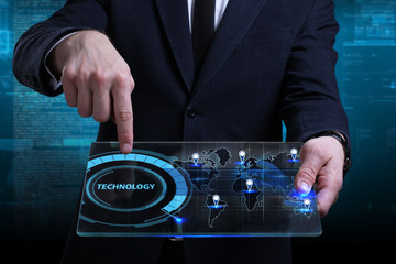 Business, Technology, Internet and network concept. Young businessman working on a virtual screen of the future and sees the inscription: Technology