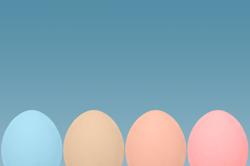 minimal set of pastel colored eggs on blue background