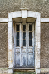 Old wooden door in abandoned house, little french village