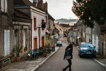 Fototapeta premium Narrow street in old french city Vezelay, evening time