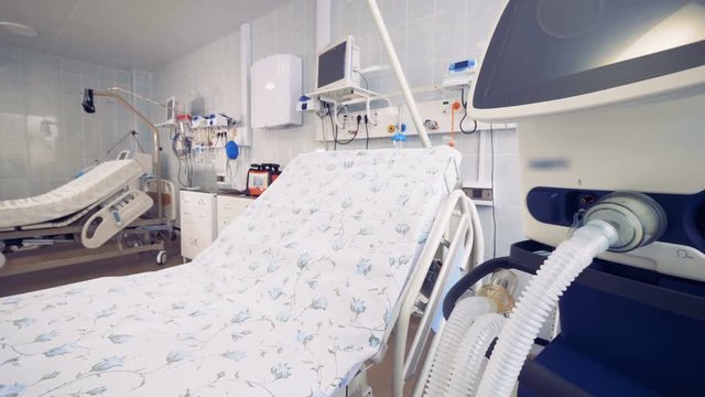 One of two patient's beds located in a hospital room is shown in a close up