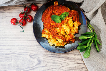 tasty fusilli pasta Italian meat sauce pasta on the table