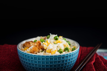 Homemade Chinese fried rice with vegetables and fried eggs