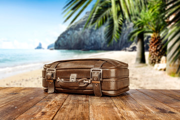 Suitcase and summer time on beach. 