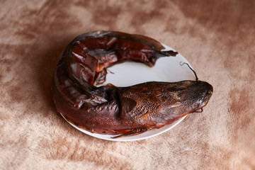Smoked catfish is placed on a plate