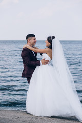 Walk newlyweds by the sea.