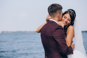 Walk newlyweds by the sea.