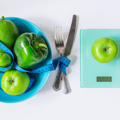 healthy food concept. overhead view of fruits and vegetables on plate with weight on white background. copy space