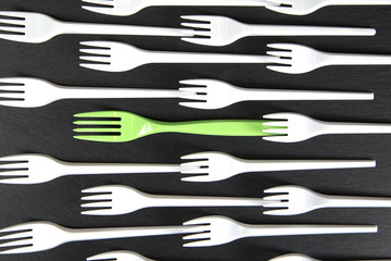 Plastic fork white and a green in between