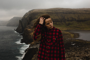 A Woman With Long Hair Blowing in the Wind By The Ocean