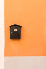 Old brown mail box on colorful wall