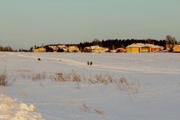snow-covered field in the background of the village