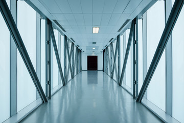 empty long corridor in modern building, might be an office, public building, exhibition grounds or...