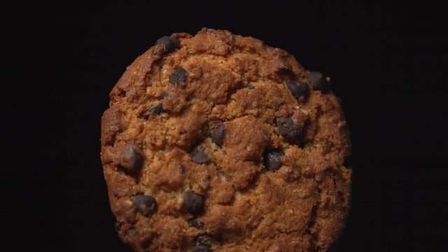 cookie with chocolate rotates on a black background