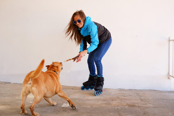 Outdoors lifestyle portrait of a beautiful girl wearing roller s