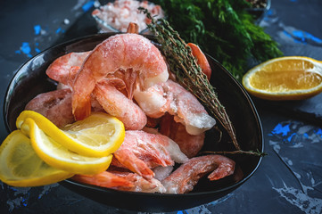 Frozen cooked shrimp to cooking with lemon dill and spices. Close up.
