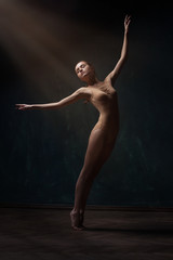 young beautiful ballet dancer in beige swimsuit