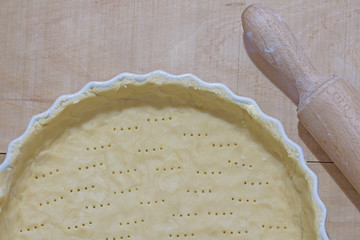 Base of raw and riddled shortcrust pastry ready to be baked.