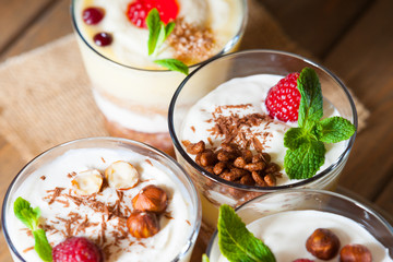 Dessert with berries, jelly, cream, nuts and mint leaf 