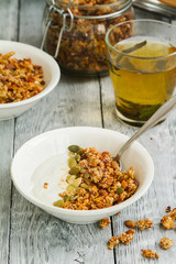Granola Breakfast with yogurt in a plate and herbal tea