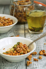 Granola Breakfast with yogurt in a plate and herbal tea