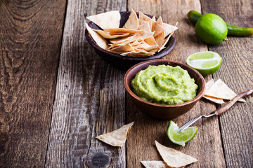 Fresh guacamole dip with lime juice and handmade nachos