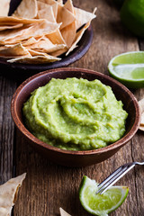 Fresh guacamole dip with lime juice and handmade nachos