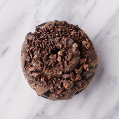 Chocolate donut on marble