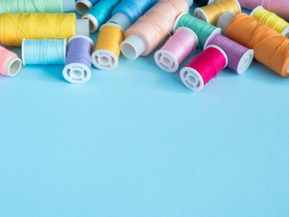 Multicolored sewing buttons on blue background with copy space flat clutch