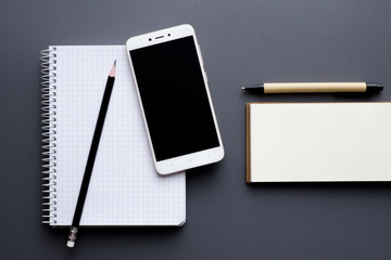 blank notepad and notebook with smartphone, pencil and pen