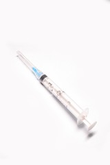 Medical syringe closeup on white background isolated