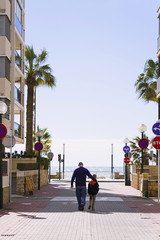 boy with his father walking in the city by the sea Spain Salou in the spring