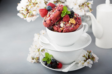 Berry shortcake donuts in a white cup