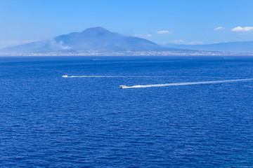 Fototapeta premium Boat in front of Mount Vesuvius in Bay of Naples at Sorrento resort town