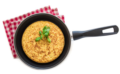 Spanish potato omelet (tortilla de patatas) isolated on white background in a frying pan, top view