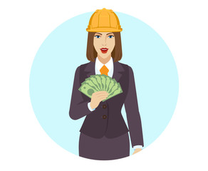 Businesswoman in construction helmet with money